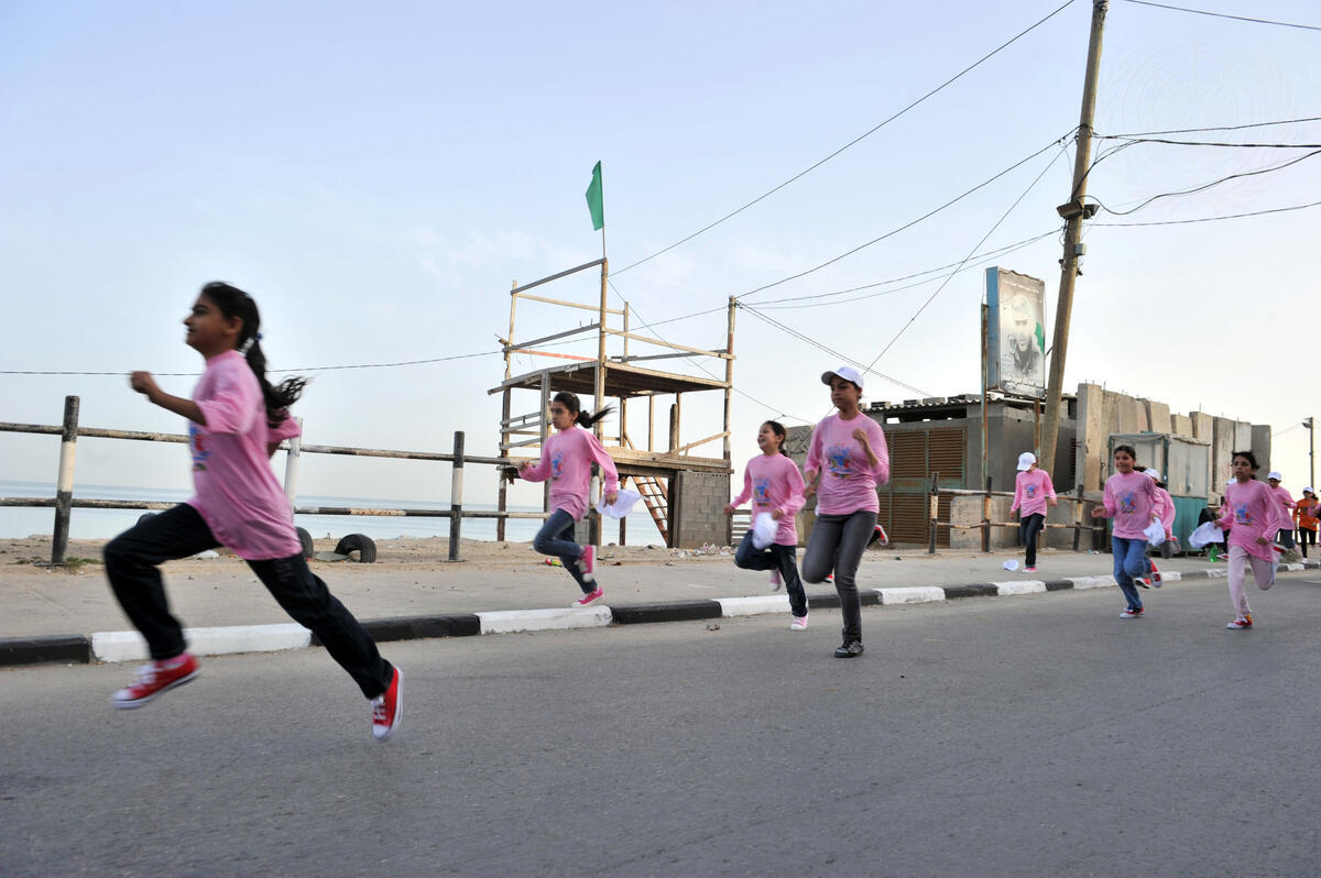 Children run in a marathon organized by the UN Relief and Works Agency for Palestine Refugees in the Near East (UNRWA), in the Gaza Strip. Spanning the entire Strip, from Beit Hanoun to Rafah, it is UNRWA’s first-ever marathon and will serve to raise funds toward its popular Summer Games programme for Palestinian children [5 May 2011,UN Photo/Shareef Sarhan]