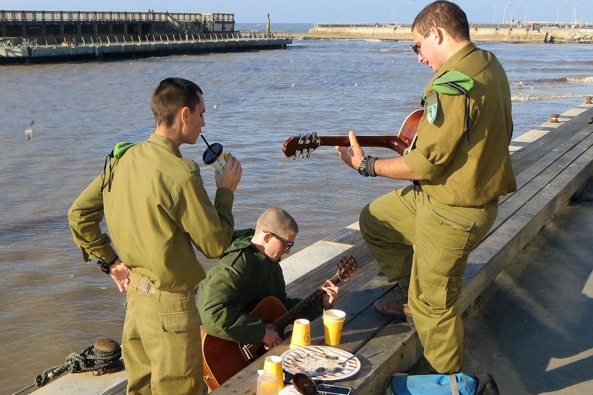 Israeli soldiers seen relaxing with guitars after a meal on Dec 15, 2013 [Alan Kotok / Flickr]